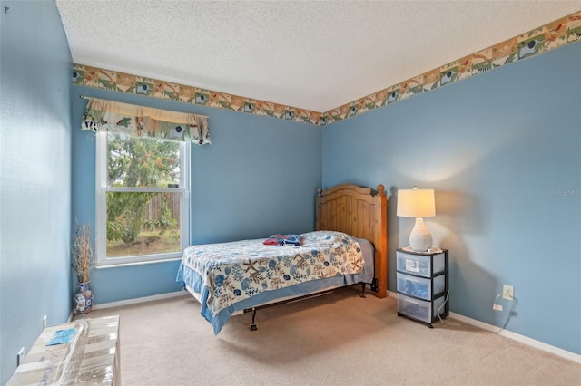 carpeted bedroom with a textured ceiling and baseboards