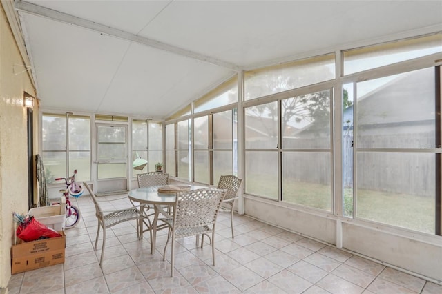 sunroom / solarium featuring vaulted ceiling