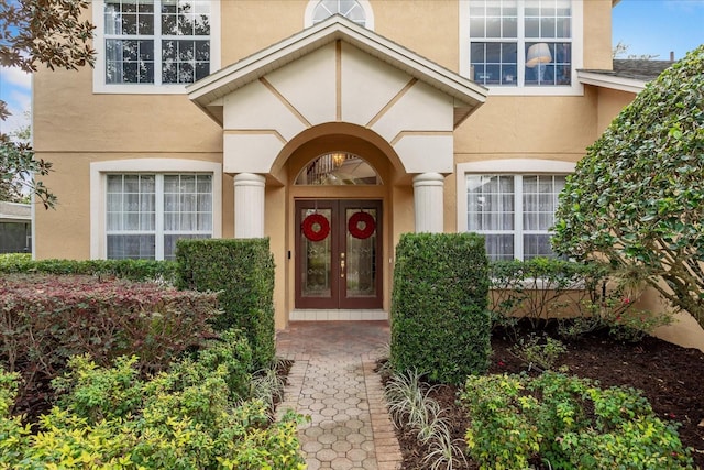 doorway to property with french doors and stucco siding