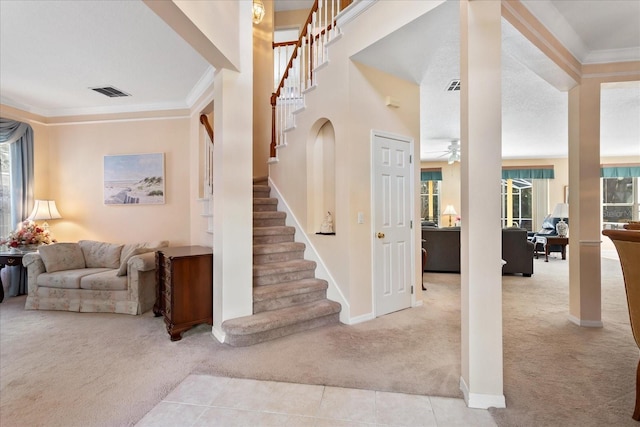 8606 Terrace Pines Ct, Orlando, FL 32836 - stairs with tile patterned flooring, carpet floors, visible vents, baseboards, and crown molding