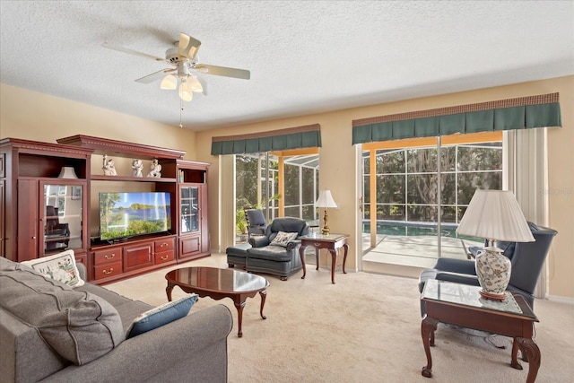 8606 Terrace Pines Ct, Orlando, FL 32836 - living area featuring a sunroom, carpet flooring, ceiling fan, and a textured ceiling