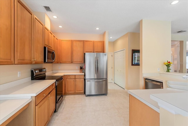 8606 Terrace Pines Ct, Orlando, FL 32836 - kitchen with light countertops, appliances with stainless steel finishes, a sink, and visible vents
