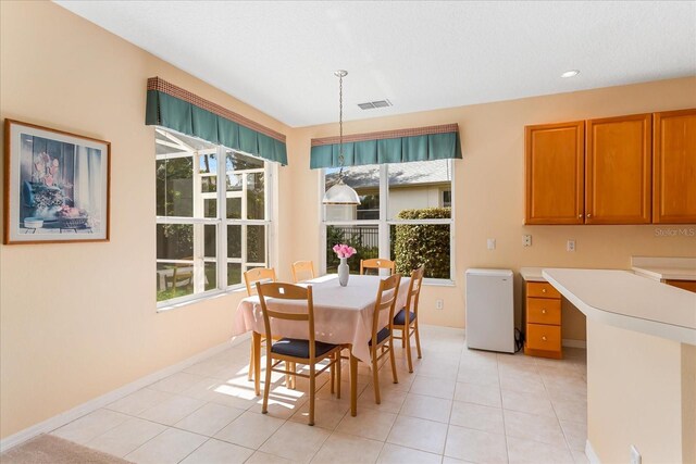 8606 Terrace Pines Ct, Orlando, FL 32836 - dining room with light tile patterned floors, built in desk, visible vents, and baseboards
