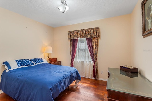 8606 Terrace Pines Ct, Orlando, FL 32836 - bedroom with a textured ceiling, wood-type flooring, and baseboards