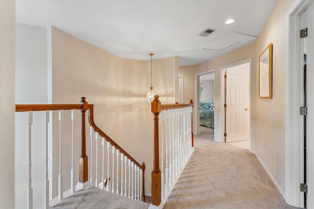 8606 Terrace Pines Ct, Orlando, FL 32836 - corridor featuring visible vents, baseboards, an upstairs landing, carpet, and attic access