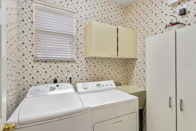 8606 Terrace Pines Ct, Orlando, FL 32836 - washroom featuring a sink, wallpapered walls, washer and dryer, and cabinet space