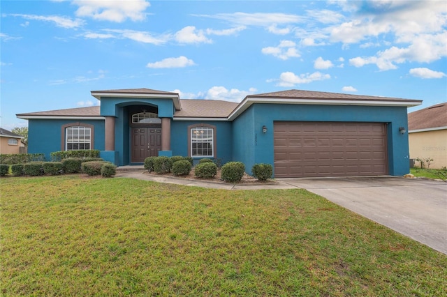 2851 Stonewood Cir, Lakeland, FL 33810 - ranch-style house with driveway, a front lawn, an attached garage, and stucco siding