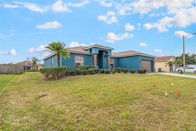 2851 Stonewood Cir, Lakeland, FL 33810 - view of front facade featuring a garage, driveway, a front yard, and stucco siding
