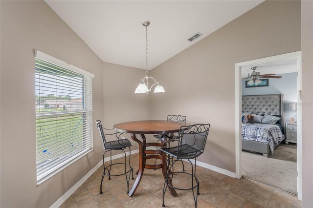 2851 Stonewood Cir, Lakeland, FL 33810 - carpeted dining area featuring lofted ceiling, visible vents, baseboards, and ceiling fan with notable chandelier