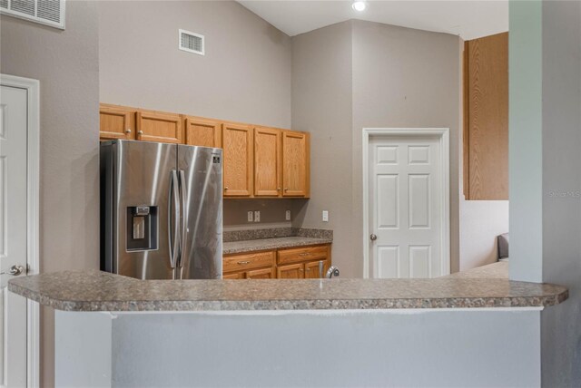 2851 Stonewood Cir, Lakeland, FL 33810 - kitchen with visible vents, stainless steel refrigerator with ice dispenser, and a peninsula