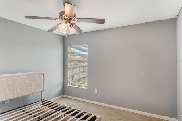 2851 Stonewood Cir, Lakeland, FL 33810 - unfurnished bedroom featuring light carpet, a ceiling fan, and baseboards