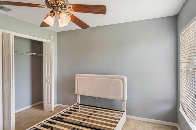 2851 Stonewood Cir, Lakeland, FL 33810 - unfurnished bedroom featuring baseboards, visible vents, a ceiling fan, light colored carpet, and a closet