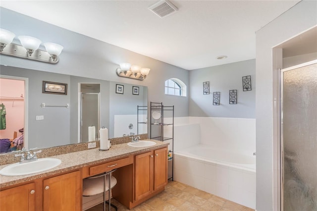 2851 Stonewood Cir, Lakeland, FL 33810 - full bath featuring visible vents, a stall shower, a sink, and a bath