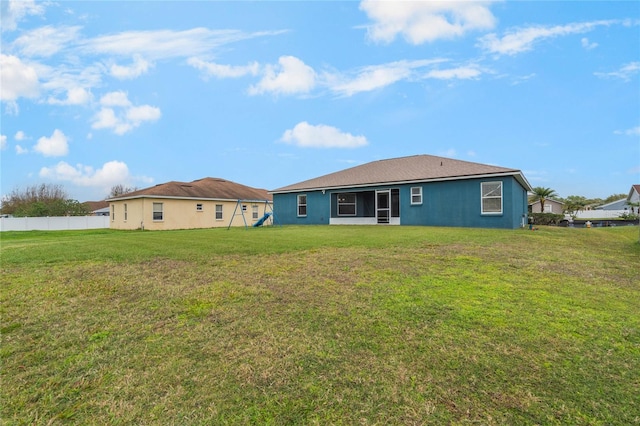 2851 Stonewood Cir, Lakeland, FL 33810 - rear view of house with stucco siding, a yard, and fence