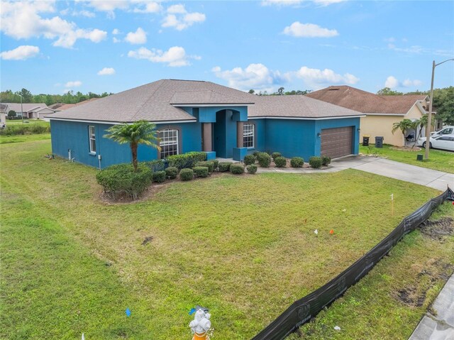 2851 Stonewood Cir, Lakeland, FL 33810 - view of front of property featuring an attached garage, a front lawn, concrete driveway, and stucco siding