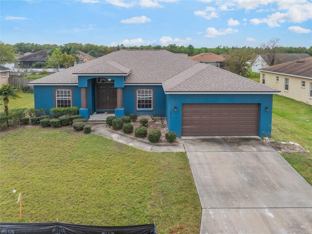2851 Stonewood Cir, Lakeland, FL 33810 - ranch-style house with a garage, driveway, a front yard, and stucco siding