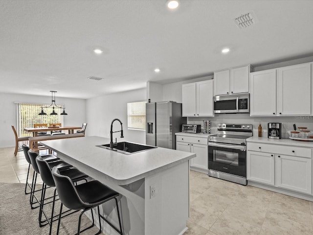 2925 SW 172nd Lane Rd, Ocala, FL 34473 - kitchen with visible vents, appliances with stainless steel finishes, a breakfast bar area, and a sink