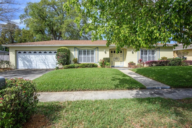 single story home featuring an attached garage, driveway, and a front lawn