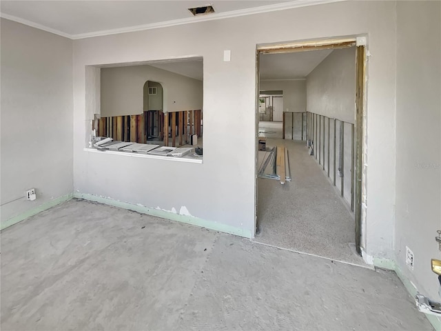 unfurnished room featuring unfinished concrete flooring, visible vents, and crown molding