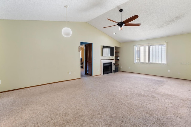 unfurnished living room with light carpet, a ceiling fan, a tile fireplace, a textured ceiling, and high vaulted ceiling