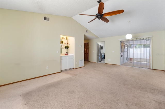 unfurnished living room with ceiling fan, baseboards, visible vents, and light colored carpet