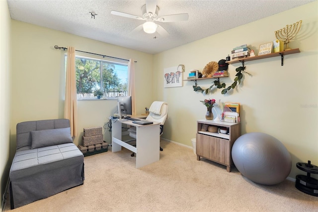 office with light carpet, baseboards, a ceiling fan, and a textured ceiling