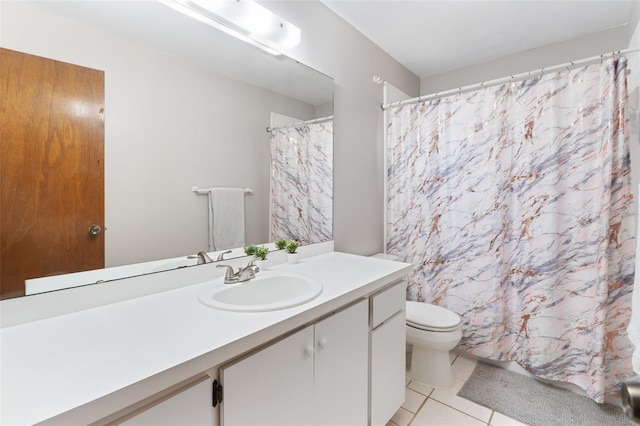 bathroom featuring toilet, vanity, a shower with shower curtain, and tile patterned floors