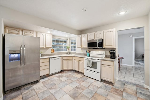 101 Ludlow Dr, Longwood, FL 32779 - kitchen with a sink, baseboards, appliances with stainless steel finishes, and light countertops