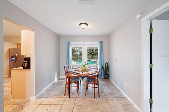 101 Ludlow Dr, Longwood, FL 32779 - dining room with light tile patterned flooring, french doors, baseboards, and a textured ceiling