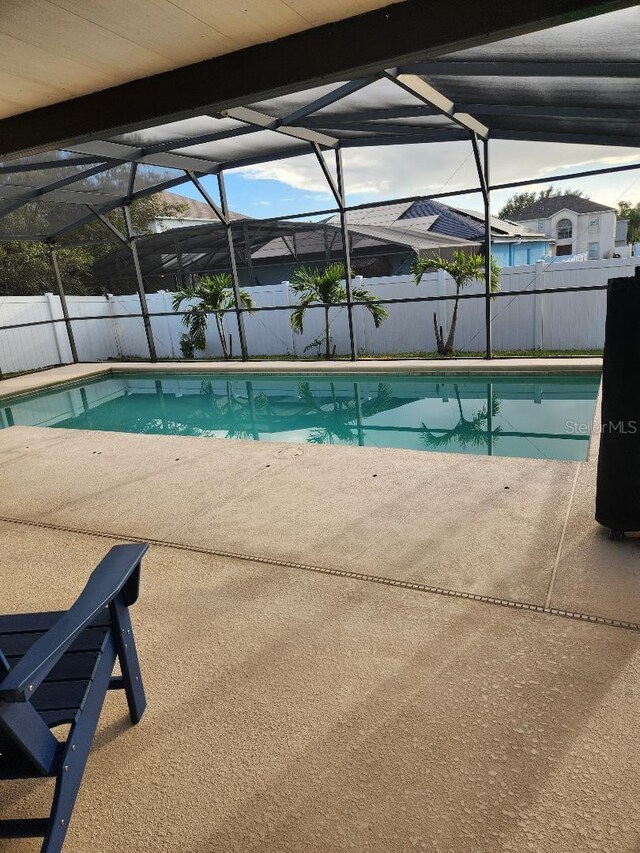 view of pool featuring a lanai, a fenced in pool, a fenced backyard, and a patio area