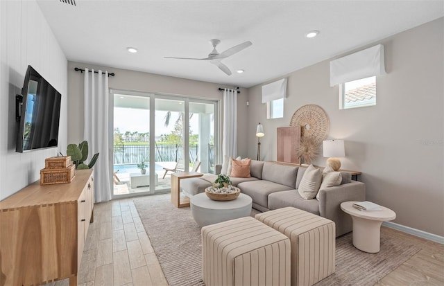 living area with light wood finished floors, baseboards, a ceiling fan, and recessed lighting