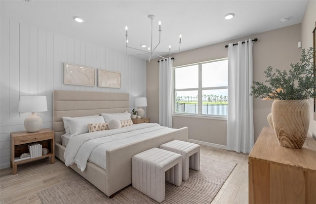 bedroom with a chandelier, light wood-type flooring, baseboards, and recessed lighting