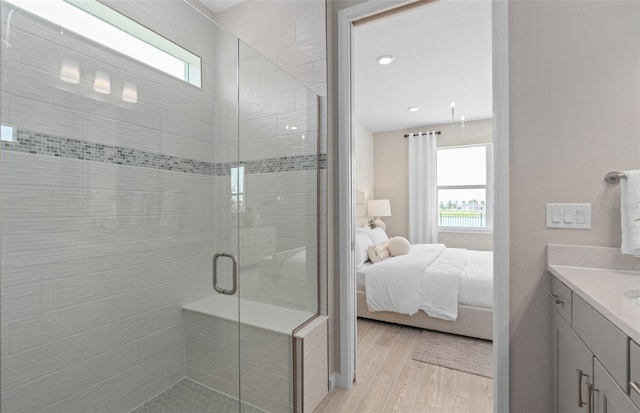 bathroom featuring a stall shower, plenty of natural light, connected bathroom, and vanity