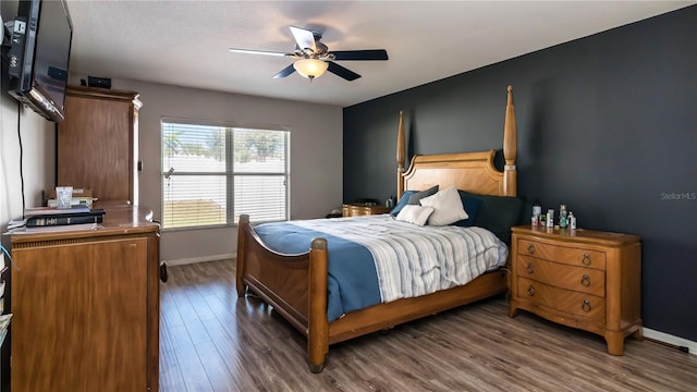 bedroom with baseboards, wood finished floors, and a ceiling fan