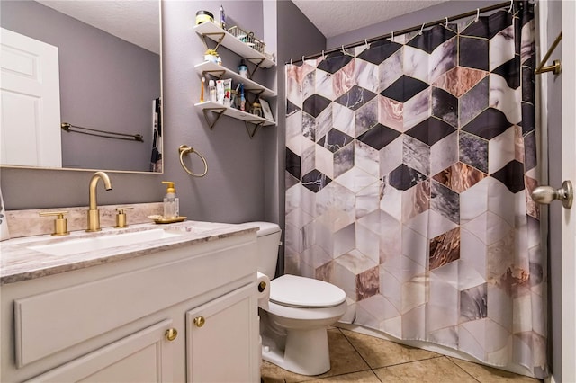 bathroom featuring toilet, a shower with shower curtain, vanity, tile patterned floors, and a textured ceiling