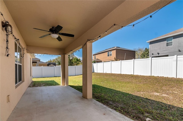 view of patio with a fenced backyard and ceiling fan