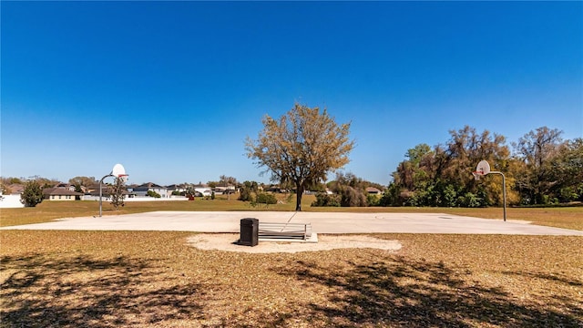 view of home's community featuring a yard and community basketball court