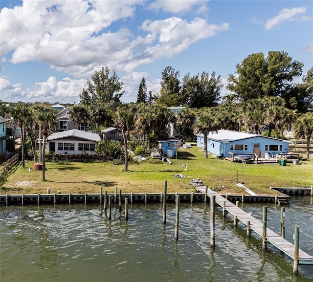 dock area with a yard and a water view