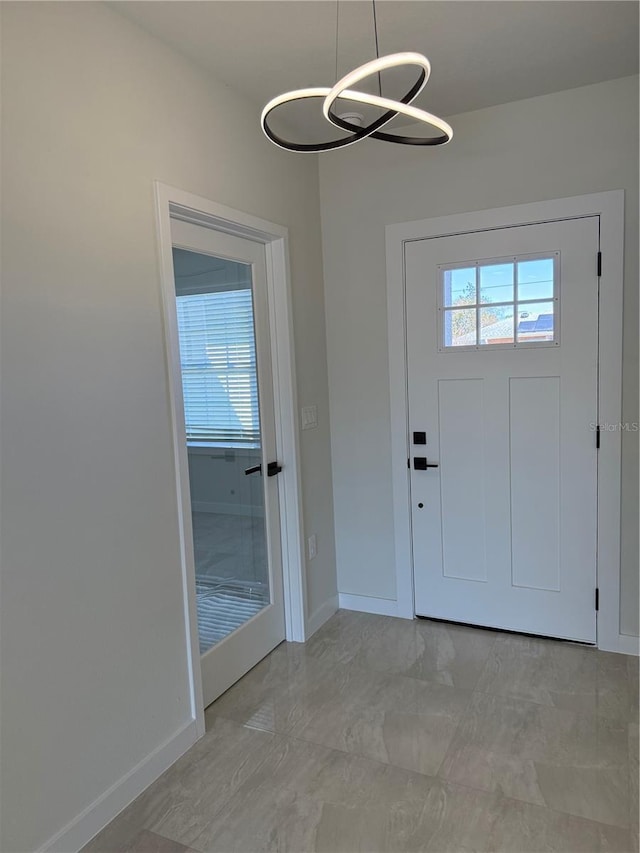 entrance foyer featuring a wealth of natural light and baseboards