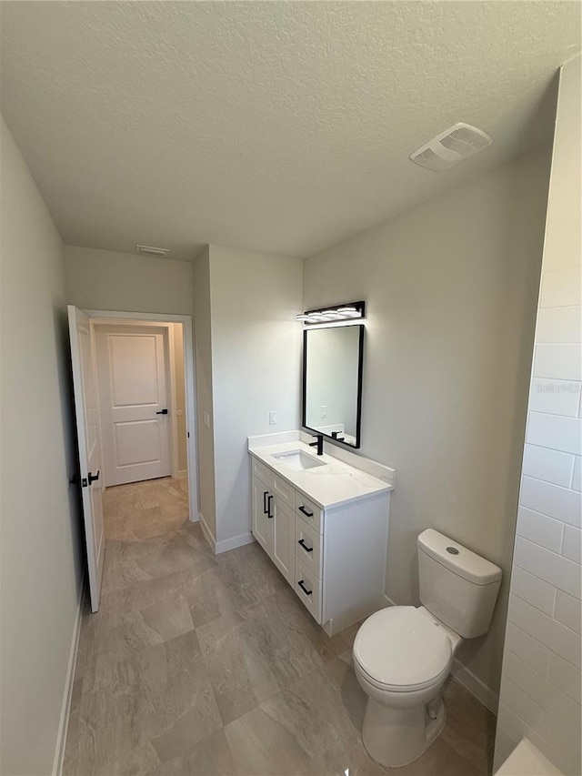 bathroom with toilet, baseboards, visible vents, and vanity