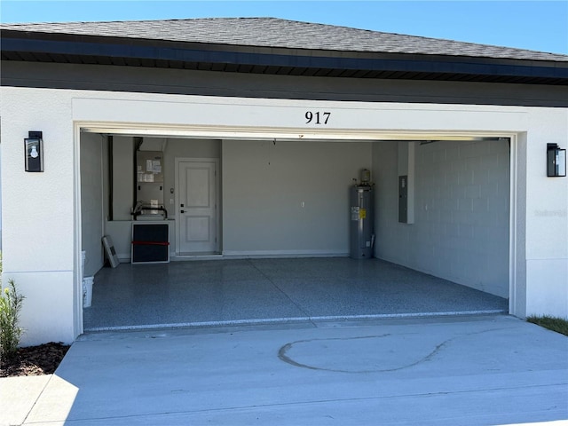 garage with concrete driveway and water heater