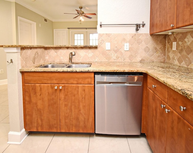 kitchen with a sink, light stone countertops, backsplash, and dishwasher