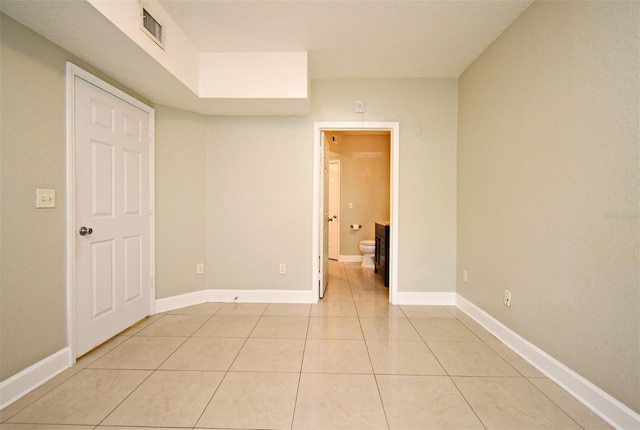 unfurnished room with light tile patterned floors, baseboards, and visible vents