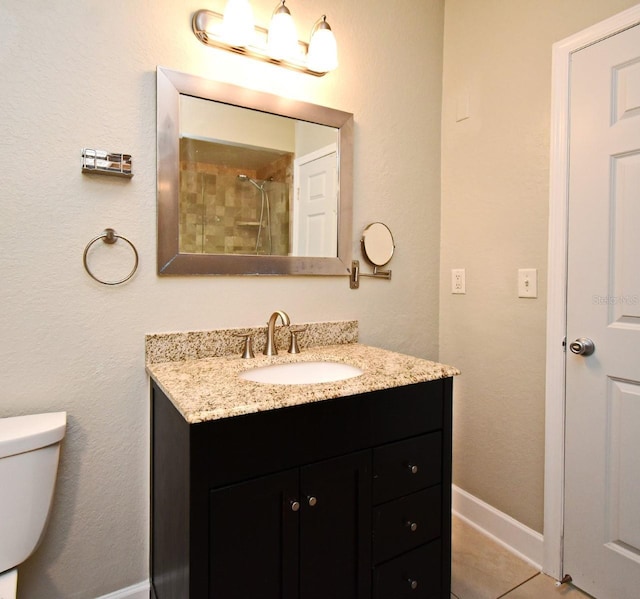 full bathroom with baseboards, toilet, tile patterned floors, walk in shower, and vanity