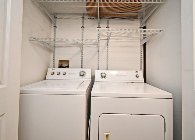 clothes washing area with laundry area and separate washer and dryer