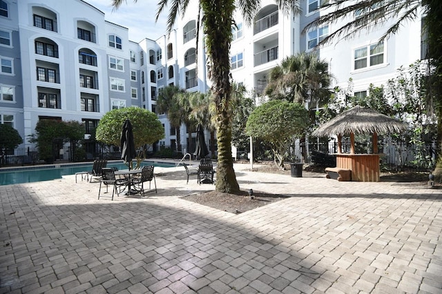 view of community featuring fence and a pool