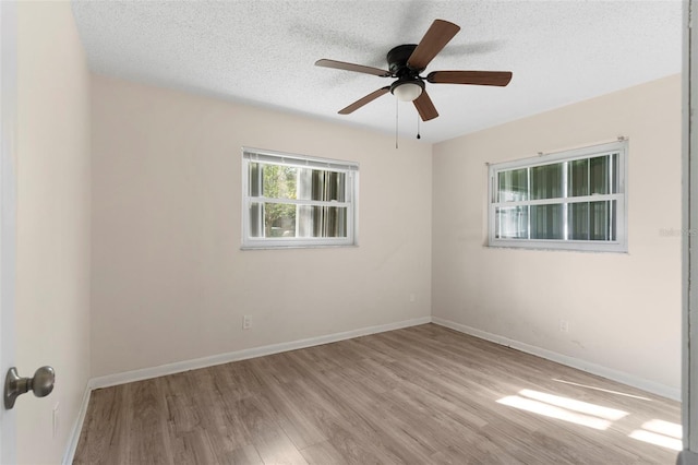 unfurnished room featuring a ceiling fan, a textured ceiling, baseboards, and wood finished floors