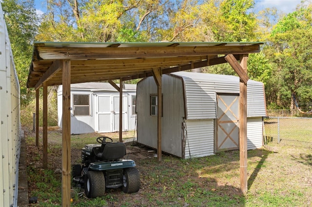 view of shed featuring fence and a detached carport