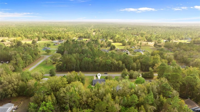 drone / aerial view with a wooded view
