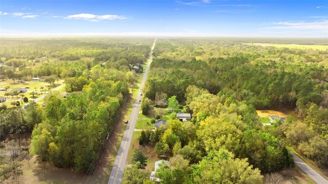 bird's eye view with a wooded view